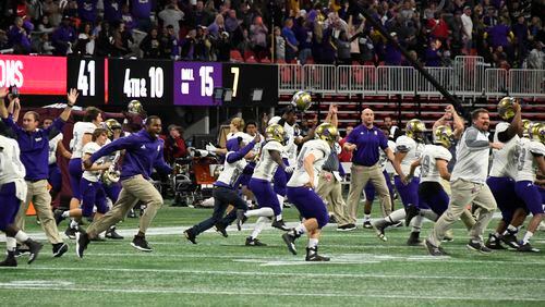 Bainbridge players and coaches celebrate after Warner Robins is unable to score in the third overtime, thus winning their class 5A high school championship football game, Tuesday, Dec., 11, 2018, at Mercedes-Benz Stadium, in Atlanta. Bainbridge won in 3 overtimes 47-41.