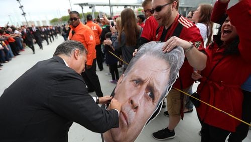 Ever obliging, on his way into Mercedes-Benz Stadium, Atlanta United coach Gerardo Martino pauses to sign his own face. (Miguel Martinez)