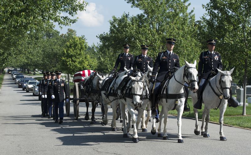 FILE - A U.S. Army Caisson team carries the casket of Army Capt. Stephanie Rader, during a full military honors conducted by the Army's 3rd U.S. Infantry Regiment through Arlington National Cemetery in Arlington, Va., June 1, 2016. The return of horse-drawn caissons at Arlington National Cemetery is being delayed for at least months or a year, the Army said Friday, April 12, 2024, as officials struggle to improve the care of the horses, after two died in 2022 as a result of poor feed and abysmal living conditions. (AP Photo/Molly Riley, File)