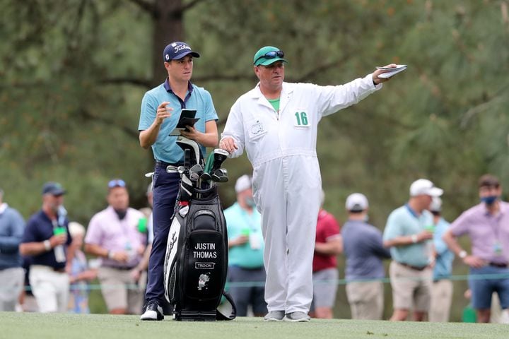April 9, 2021, Augusta: Justin Thomas and his caddie James Johnson discuss Thomas’ fairway shot on the fifteenth hole during the second round of the Masters at Augusta National Golf Club on Friday, April 9, 2021, in Augusta. Curtis Compton/ccompton@ajc.com