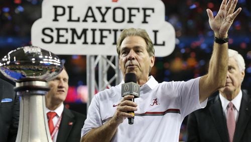 Nick Saban much prefers talking about the semifinal trophy he just won in Atlanta to discussing the comings and goings of Lane Kiffin. (Curtis Compton/ccompton@ajc.com)