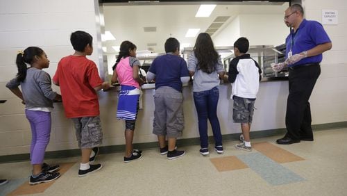 Immigrant children line up in the cafeteria at the Karnes County Residential Center, a detention center for immigrant families, in Karnes City, Texas. Sept. 10, 2014. AP Photo/Eric Gay