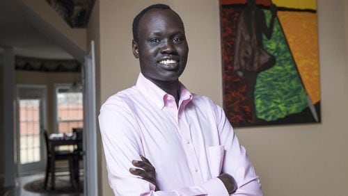 When Abraham Deng Ater left South Sudan as a child, he promised his father he would pursue an education. Ater, shown in his home in Snellville, is a public health researcher for the Centers for Disease Control and Prevention, working as a contractor from Northrop Grumman. He recently graduated from Georgia Southern University with his doctor of public health in public health leadership.