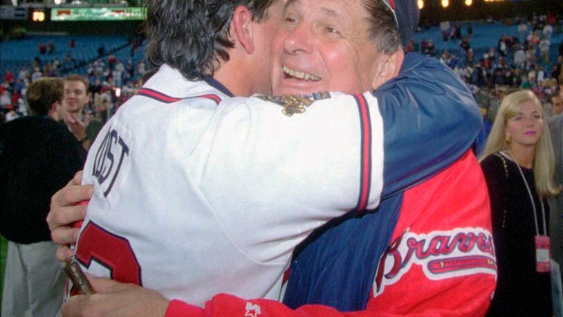 Manger Bobby Cox, right, hugs bullpen coach Ned Yost after the Braves locked up the World Series against Cleveland 25 years ago. (AP Photo/John Bazemore, File)