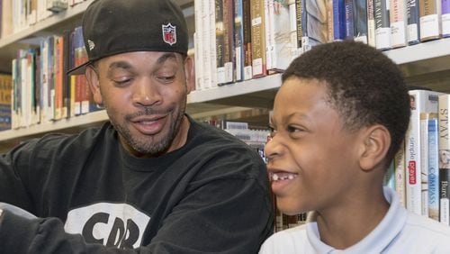 La Verio Barnes and his son Anderson, 8, regularly go to the Kirkwood Branch library in Atlanta after Anderson gets out of school. Barnes, an Atlanta DJ and musician, is the founder of the charity Cool Dads Rock, an organization that helps fathers form positive relationships with their children. DAVID BARNES / DAVID.BARNES@AJC.COM