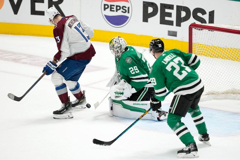 Dallas Stars goaltender Jake Oettinger (29) and defenseman Esa Lindell (23) defend against a shot, and pressure at the net from Colorado Avalanche right wing Valeri Nichushkin (13), during the third period in Game 2 of an NHL hockey Stanley Cup second-round playoff series in Dallas, Thursday, May 9, 2024. (AP Photo/Tony Gutierrez)