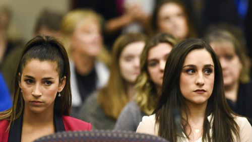 Former Olympians Aly Raisman, left, and Jordyn Wieber sit in Circuit Judge Rosemarie Aquilina's courtroom during the fourth day of sentencing for former sports doctor Larry Nassar, who pled guilty to multiple counts of sexual assault, Friday, Jan. 19, 2018, in Lansing, Mich. (Matthew Dae Smith /Lansing State Journal via AP)