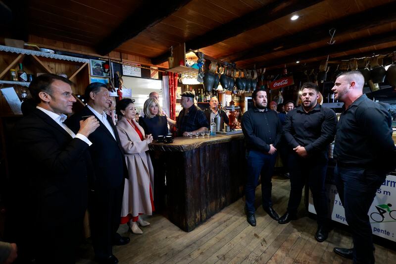 Chinese President Xi Jinping, second left, and his wife Peng Liyuan, third left, French President Emmanuel Macron, left, and his wife Brigitte Macron listen to singers in a restaurant, Tuesday, May 7, 2024 at the Tourmalet pass, in the Pyrenees mountains. French president is hosting China's leader at a remote mountain pass in the Pyrenees for private meetings, after a high-stakes state visit in Paris dominated by trade disputes and Russia's war in Ukraine. French President Emmanuel Macron made a point of inviting Chinese President Xi Jinping to the Tourmalet Pass near the Spanish border, where Macron spent time as a child visiting his grandmother. (AP Photo/Aurelien Morissard, Pool)
