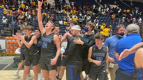 Towns County players and coaches celebrate their 64-60 victory over Hancock Central in the Class A Public boys basketball championship game Saturday, March 13, 2021, at Macon Coliseum.