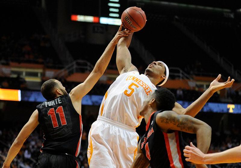 Georgia forward Cameron Forte (11), Tennessee forward Jarnell Stokes (5), and Georgia guard Charles Mann look for a rebound during the first half of an NCAA college basketball game in Knoxville, Tenn., on Tuesday, Feb. 18, 2014. Tennessee defeated Georgia 67-48. (AP Photo/The Knoxville News Sentinel, Adam Lau)