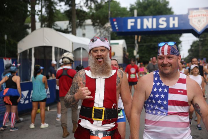 Costumed runners at the finish of the 54th running of The Atlanta Journal-Constitution Peachtree Road Race on Tuesday, July 4, 2023.   (Jason Getz / Jason.Getz@ajc.com)