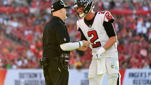 Falcons head coach Dan Quinn and quaterback Matt Ryan discuss the next play during the final minute of a 34-32 win over Tampa Bay Buccaneers Dec. 30, 2018, at Raymond James Stadium in Tampa, Fla.