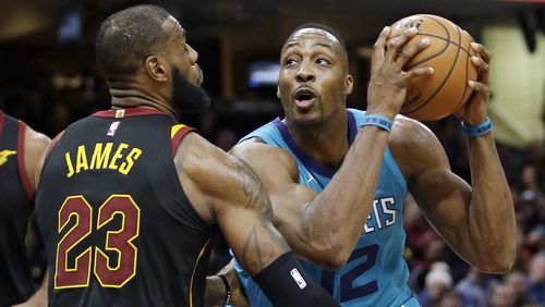 Charlotte Hornets' Dwight Howard (12) drives against Cleveland Cavaliers' LeBron James (23) in the second half of an NBA basketball game, Friday, Nov. 24, 2017, in Cleveland. (AP Photo/Tony Dejak)