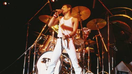Freddie Mercury (1946-1991), singer with Queen, standing in front of a drumkit as he sings into a microphone on stage during a live concert performance by the band at the National Bowl in Milton Keynes, England, United Kingdom, on 5 June 1982. The band's anthem, "We Will Rock You" remains a staple at sporting events.