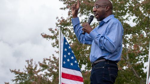 Democrat Raphael Warnock addresses a crowd at a Gwinnett County rally on Oct. 24, 2020. (OLIVIA HAYDEN / AJC)