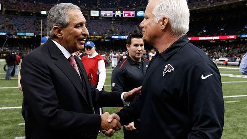 NEW ORLEANS, LA - DECEMBER 21: Head coach Mike Smith of the Atlanta Falcons meets with owner Arthur Blank following a game against the New Orleans Saints at the Mercedes-Benz Superdome on December 21, 2014 in New Orleans, Louisiana. (Photo by Sean Gardner/Getty Images) "Congratulations on beating Saints, Smitty. By the way, I've hired a search firm." (Getty Images)