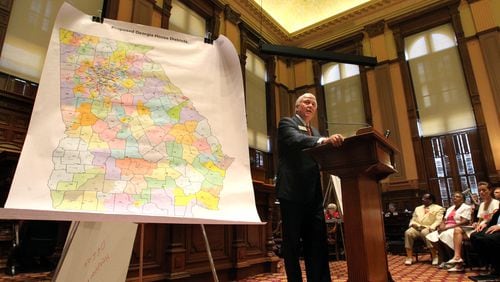 Competitive districts – in which either a Republican or a Democrat has a shot at winning – are an endangered species in Georgia. Here, Rep. Roger Lane, R-Darien, unveils the proposed map of House districts in 2011. AJC FILE