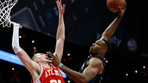 Dwight Howard loads up for an extra large dunk, and there's nothing the Hawks Mike Muscala can do about it.  (AP Photo/John Bazemore)