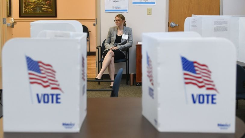 Poll worker Brittni Nix waits to assist voters during special election voting in Dacula in March. A civil rights group said Gwinnett County was required to send Spanish-language absentee ballot applications, but an attorney for the elections board disagrees. ALYSSA POINTER / AJC FILE PHOTO