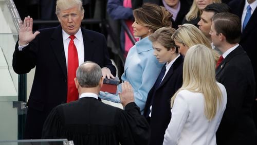 Donald Trump is sworn in as the 45th president of the United States by Chief Justice John Roberts as Melania Trump looks on during the 58th Presidential Inauguration at the U.S. Capitol in Washington, Friday, Jan. 20, 2017. (AP Photo/Matt Rourke)