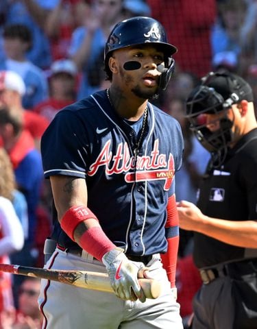 Atlanta Braves shortstop Dansby Swanson walks in the dugout during