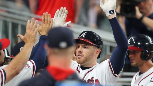 Freddie Freeman is congratulated after his second home run of Tuesday’s win against the Padres, an eighth-inning solo shot that tied the game. (Curtis Compton/ccompton@ajc.com)