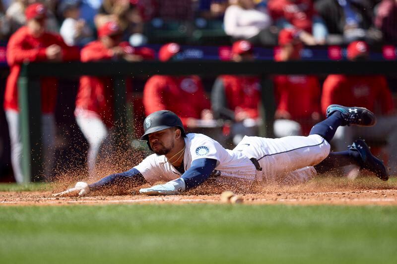 Seattle Mariners' Jonatan Clase scores against the Cincinnati Reds during the seventh inning of a baseball game Wednesday, April 17, 2024, in Seattle. The Mariners won 5-1. (AP Photo/John Froschauer)