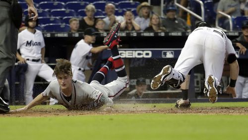 Braves pinch-runner Max Fried scores past Marlins catcher Chad Wallach on a double hit by Ender Inciarte during the 10th inning Sunday, May 5, 2019, in Miami. The Braves won, 3-1, in 10 innings.