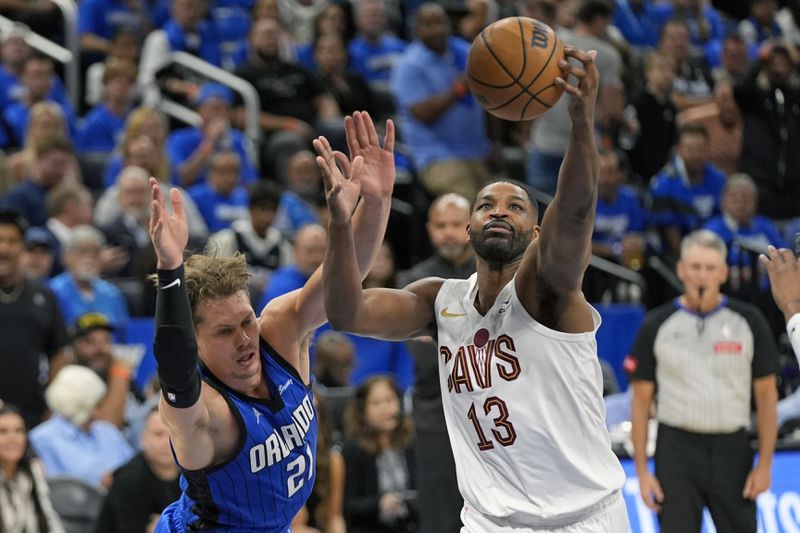 Orlando Magic center Moritz Wagner (21) loses the ball as he goes up for a shot against Cleveland Cavaliers center Tristan Thompson (13) during the second half of Game 3 of an NBA basketball first-round playoff series Thursday, April 25, 2024, in Orlando, Fla. (AP Photo/John Raoux)