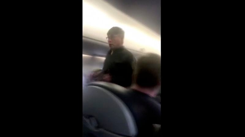 This Sunday, April 9, 2017, image made from a video provided by Audra D. Bridges shows a passenger who was removed from a United Airlines flight in Chicago. Video of police officers dragging the passenger from an overbooked United Airlines flight sparked an uproar Monday on social media, and a spokesman for the airline insisted that employees had no choice but to contact authorities to remove the man. (Audra D. Bridges via AP)
