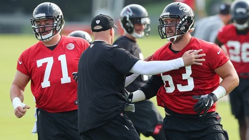 July 27, 2017 Flowery Branch: Falcons head coach Dan Quinn works with offensive guards Wes Schweitzer and Ben Garland (right) on the first day of team practice at training camp on Thursday, July 27, 2017, in Flowery Branch. Curtis Compton/ccompton@ajc.com