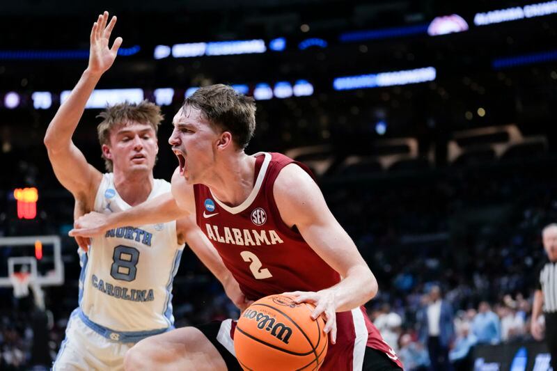 Alabama forward Grant Nelson (2) dribbles past North Carolina guard Paxson Wojcik (8) during the second half of a Sweet 16 college basketball game in the NCAA tournament Thursday, March 28, 2024, in Los Angeles. (AP Photo/Ashley Landis)