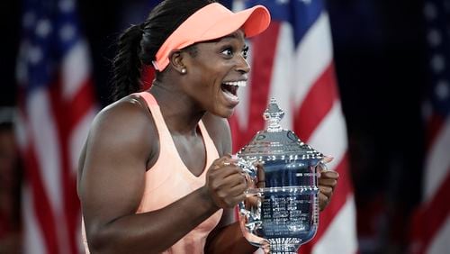 Sloane Stephens, of the United States, holds up the championship trophy after beating Madison Keys, of the United States, in the women's singles final of the U.S. Open tennis tournament, Saturday, Sept. 9, 2017, in New York. (AP Photo/Julio Cortez)