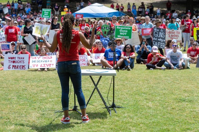 Angela Frerrell Zabala speaks to a crowd during a rally organized by Georgia Moms Demand Action in Piedmont Park Saturday, May 13, 2023. The rally was part of a national series of protests the day before Mother’s Day to highlight the mounting toll of gun violence.  (Steve Schaefer/steve.schaefer@ajc.com)