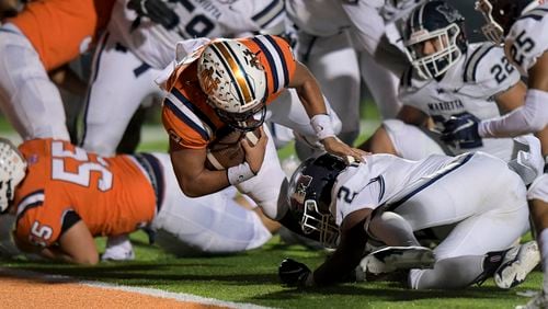 North Cobb quarterback Malachi Singleton (3) dives into the end zone to score a touchdown over Marietta free safety Luke Morgan (2) late in the second half of their game Friday, November 13, 2020 in Kennesaw. (PHOTO/Daniel Varnado)