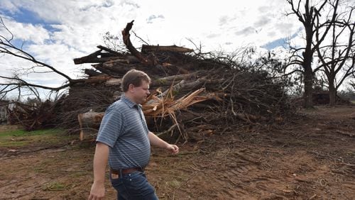 Farmer Trey Pippin walks past a pile of dead pecan trees at his farm in Albany on Feb. 5, 2019.  South Georgia farmers were hit hard by Hurricane Michael in October 2018. HYOSUB SHIN / HSHIN@AJC.COM