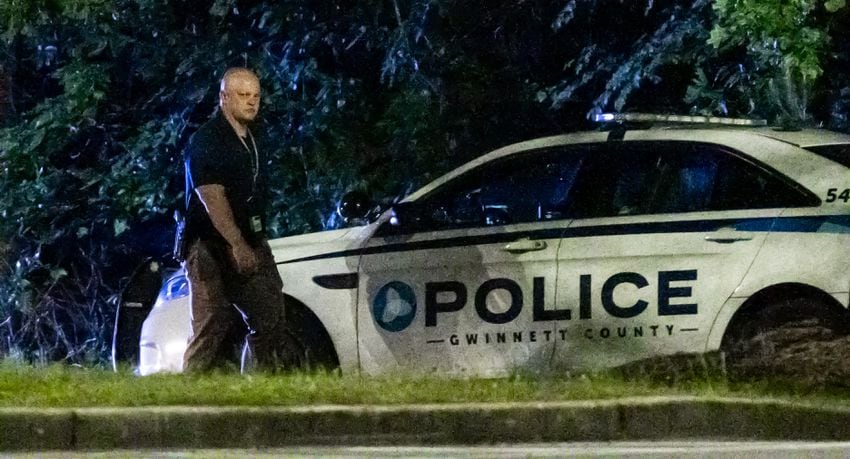 Gwinnett police examine the scene of a shooting, where a man and three children shot to death inside a car at Lucky Shoals Park outside of Tucker on Wednesday, May 8, 2024. The man was in the driver’s seat. He, a boy and two girls all appeared to have been shot. Their names and ages were not released, but authorities said the children appeared to have been in elementary and middle school.  (John Spink/AJC)