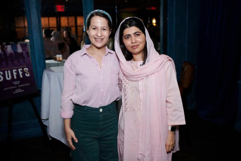 This photo provided by Rubenstein shows Malala Yousafzai, right, and and Shaina Taub, creator and star of “Suffs” pose. Yousafzai and former Secretary of State Hillary Rodham Clinton are joining together as producers of the musical about the suffragist movement. (Jenny Anderson via AP)