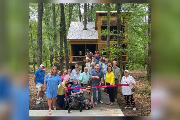 Members of Friends of Newton Parks, the Newtown County Chamber of Commerce and supporters of Chimney Park prepare to cut the ribbon on the park's new universally accessible treehouse. (Photo provided by Alice Queen)