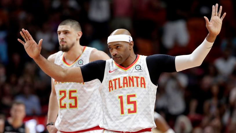 Atlanta Hawks guard Vince Carter (15) acknowledges the crowd as he is introduced during the first half of an NBA basketball game against the Miami Heat, Tuesday, Dec. 10, 2019, in Miami. (AP Photo/Lynne Sladky)