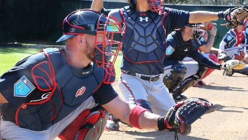 Braves catchers Tyler Flowers (left) and Kurt Suzuki work with pitchers in the bullpen Saturday, Feb 17, 2018, at the ESPN Wide World of Sports Complex in Lake Buena Vista, Fla. (Curtis Compton/ccompton@ajc.com)