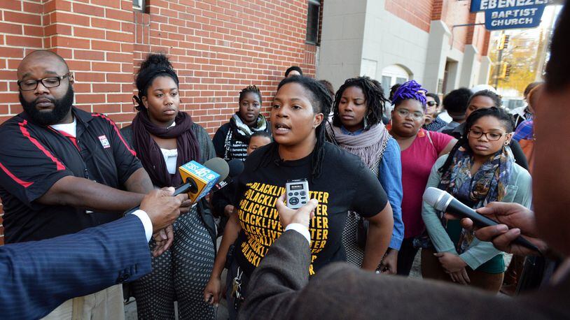 Atlanta Black Lives Matter activist and organizer Mary Hooks (center) speaks to the media on Nov. 24, 2014, outside Ebenezer Baptist Church in Atlanta, where she announced a peaceful rally at Underground Atlanta in response to developments in Ferguson, Mo., following a police officer’s fatal shooting of an unarmed black man. (BRANT SANDERLIN / bsanderlin@ajc.com)