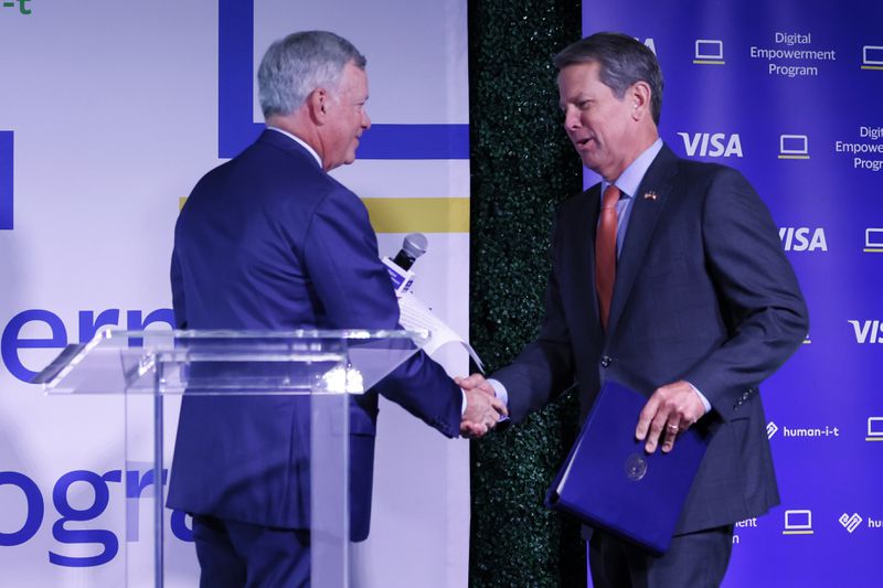 Visa CEO Alfred F Kelly Jr welcomes Gov. Brian Kemp during the Visa Digital Empower Program event in Atlanta on Tuesday, June 28, 2022. The program will provide 1,000 laptops to individuals and small businesses to help with digital access equity. Miguel Martinez / Miguel.martinezjimenez@ajc.com