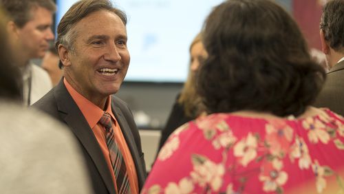 Fulton County Schools superintendent finalist Mike Looney (left) greets individuals following a news conference last week at which he was named the sole finalist for the district's top job.  (ALYSSA POINTER/ALYSSA.POINTER@AJC.COM)