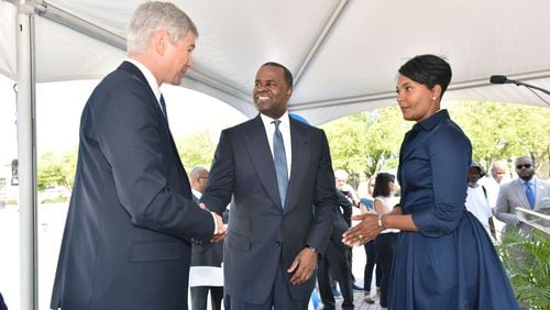 Mayor Kasim Reed shake hands as Councilwoman Keisha Lance Bottoms (right) looks on, at a ceremony announcing GSU’s purchase of Turner Field last August. Hyosub Shin, hshin@ajc.com