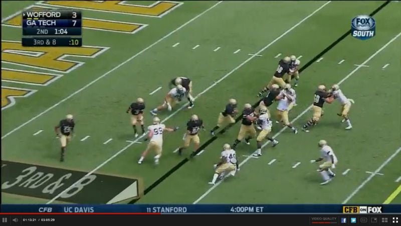 The critical frame. Initially double teamed, Green has been pushed back and to his right, and Smith is now stuck behind him. Wahrby is canceling Nealy, and running back Ray Smith has taken the ball and is running right between the two. Golden is putting on the brakes, but has run out of the play.