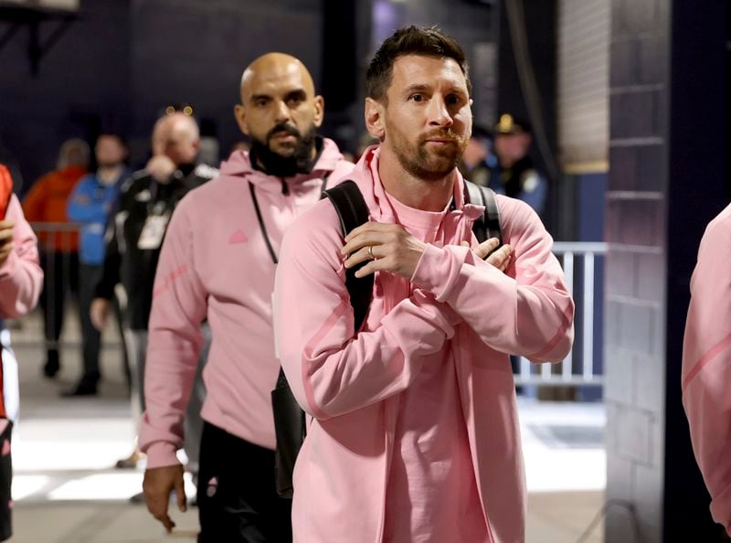 Inter Miami forward Lionel Messi, right, arrives at Gillette Stadium before an MLS soccer match against the New England Revolution, Saturday, April 27, 2024, in Foxborough, Mass. (AP Photo/Mark Stockwell)