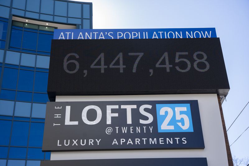 A sign at the Lofts at Twenty25 apartment complex counts the current population of Atlanta, as seen Wednesday. The ARC expects Fulton County alone to grow by 24% between 2020 and 2050. (Olivia Bowdoin for the AJC)