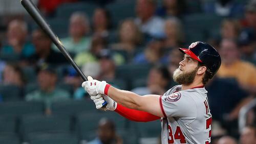 Washington Nationals right fielder Bryce Harper (34) watches his grand slam during the second inning of a baseball game against the Atlanta Braves on Wednesday, April 19, 2017, in Atlanta. It was Harper's second of the game. (AP Photo/John Bazemore)