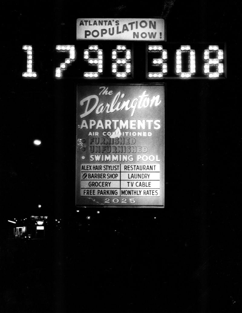 Night scene showing the sign with Atlanta's current population outside the Darlington Apartments. Jan. 1980.